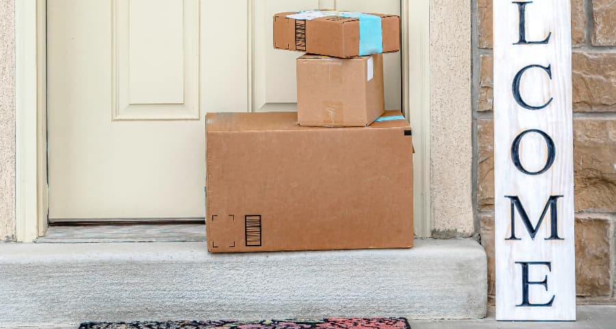 Boxes by the door of a residence with a welcome sign in Oklahoma City